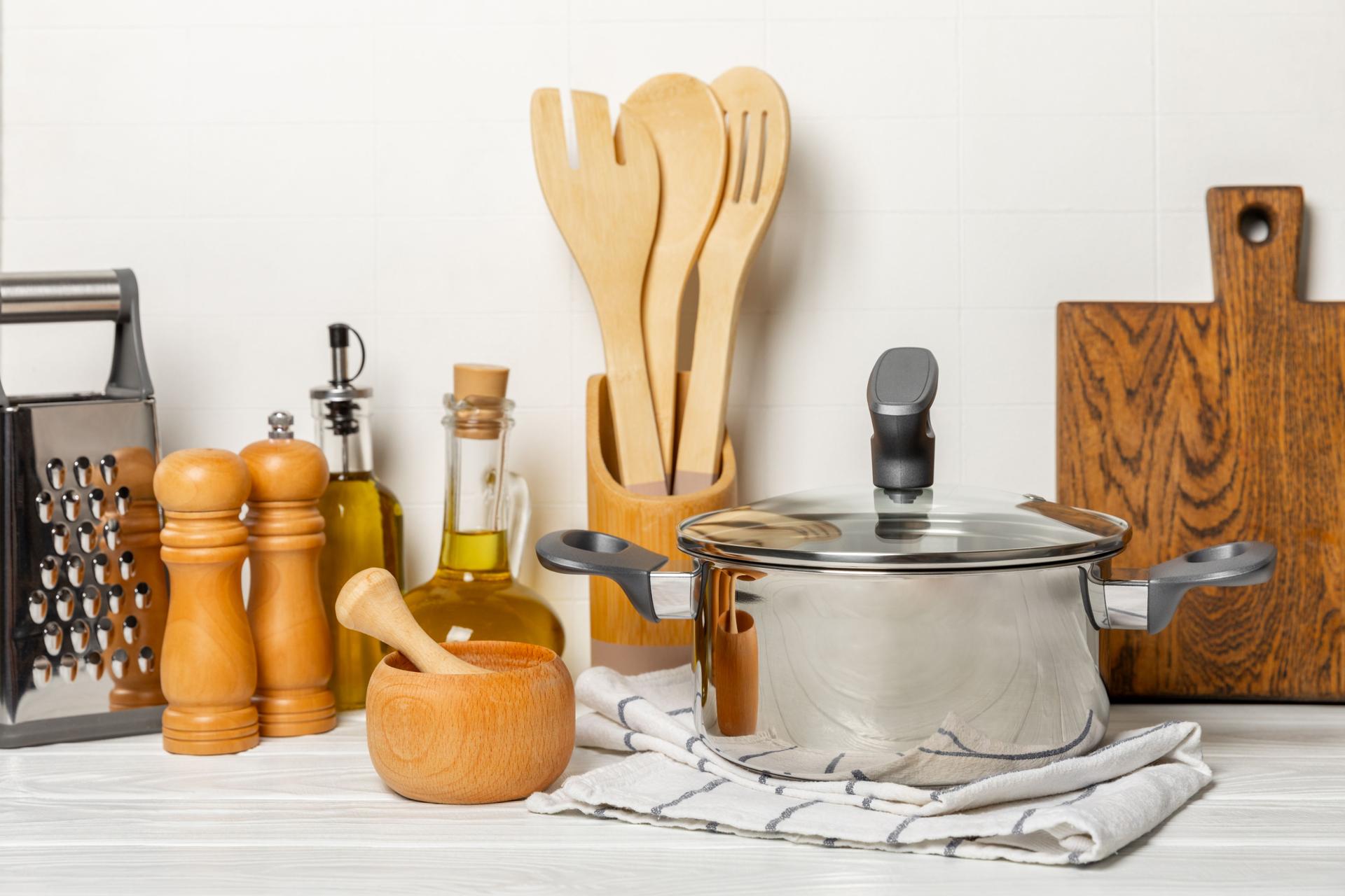 Stainless steel saucepan on light kitchen background. Modern saucepan. Kitchenware. Cooking pot. Cooking concept. Mockup. Space for text. Copy space.