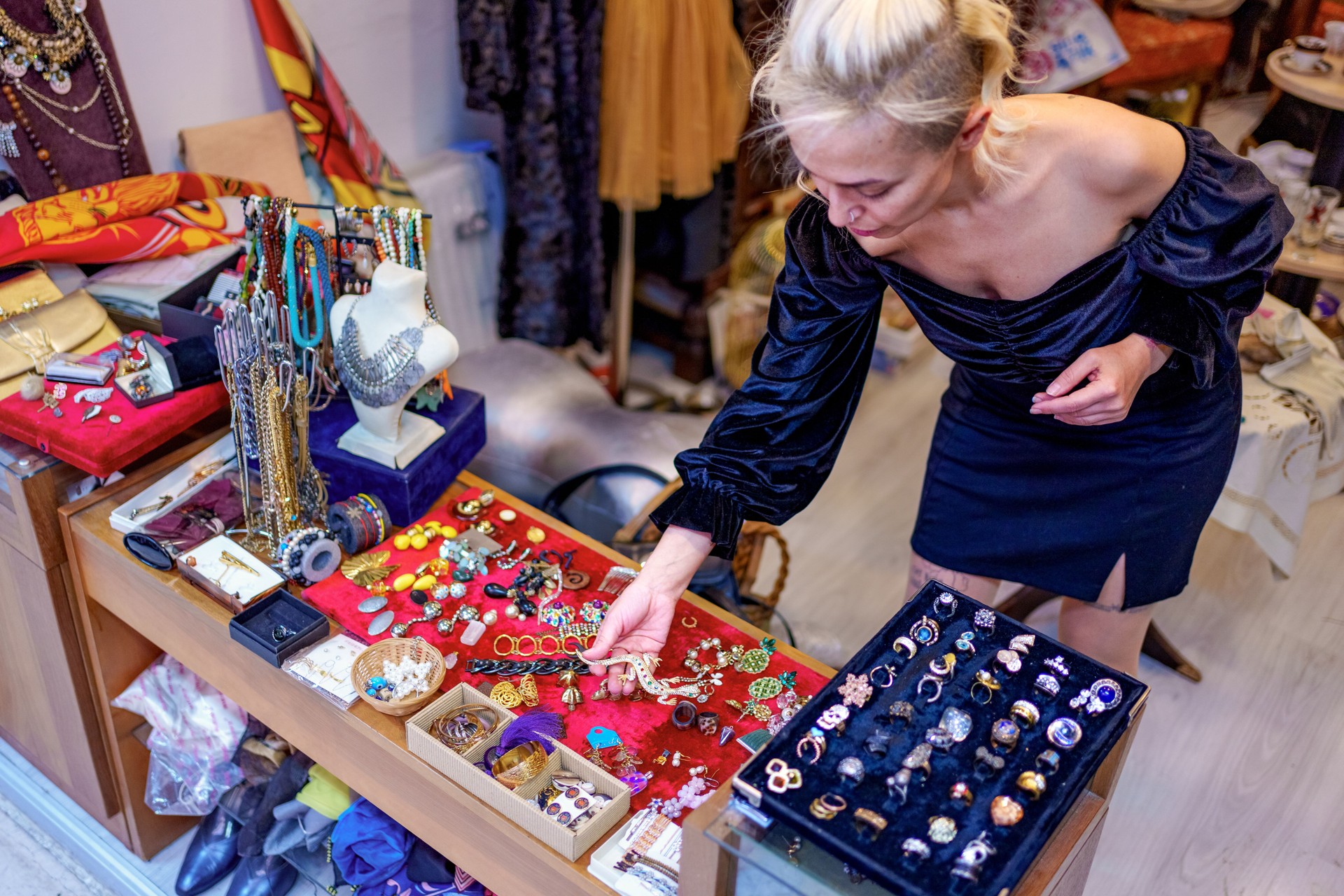 A woman browses the shelves full of second-hand and vintage jewelry in a department store